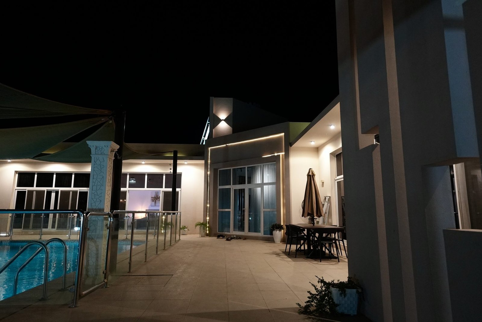 Urjoon Chalet villa and pool lit at night