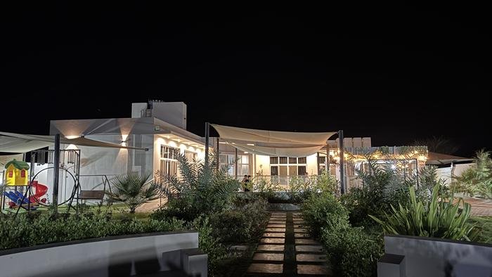 Villa facade and garden path at night